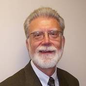 A person with a white beard and glasses

AI-generated content may be incorrect.